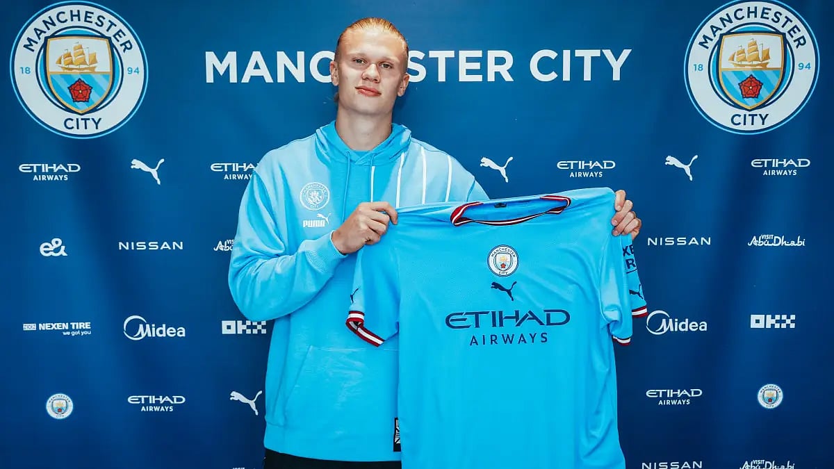 Erling Haaland poses after confirming Manchester City signing on Monday. 