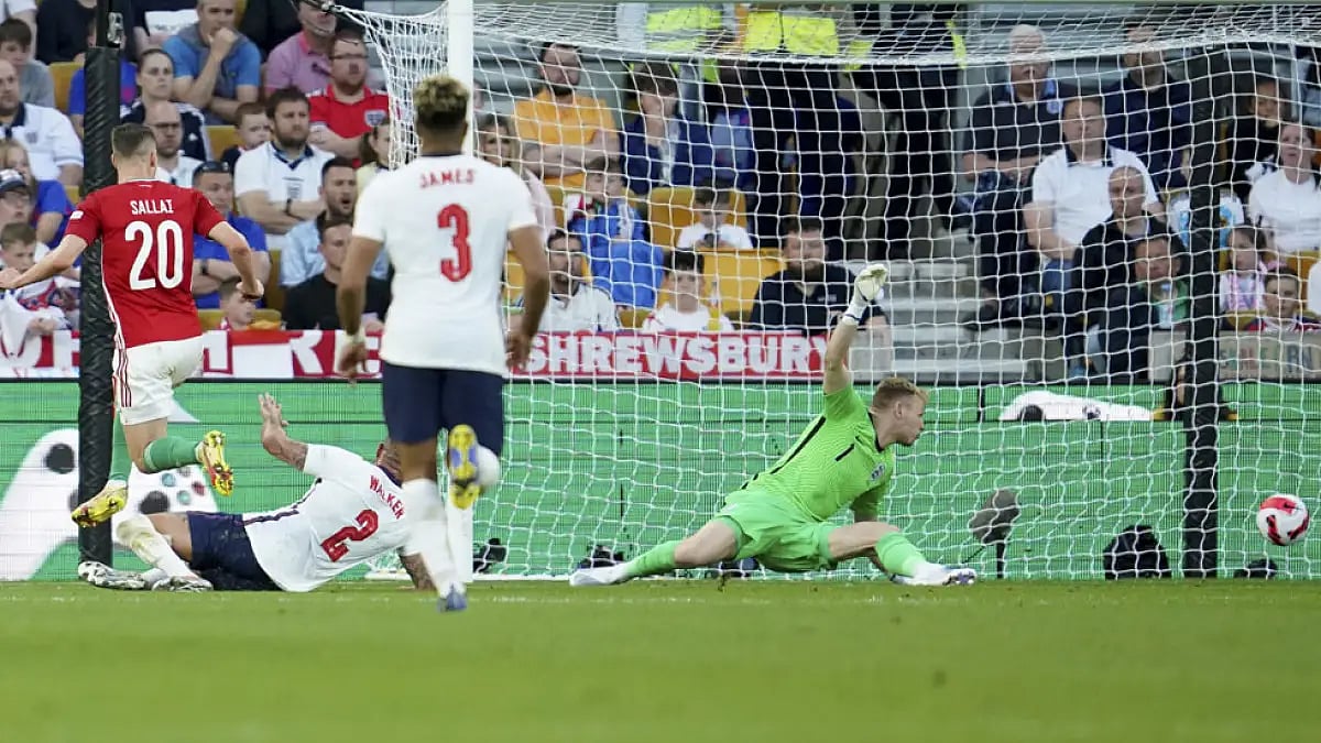 Hungary's Roland Sallai, left, scores a goal against England during their UEFA Nations League match at the Molineux stadium in Wolverhampton, June 14, 2022.