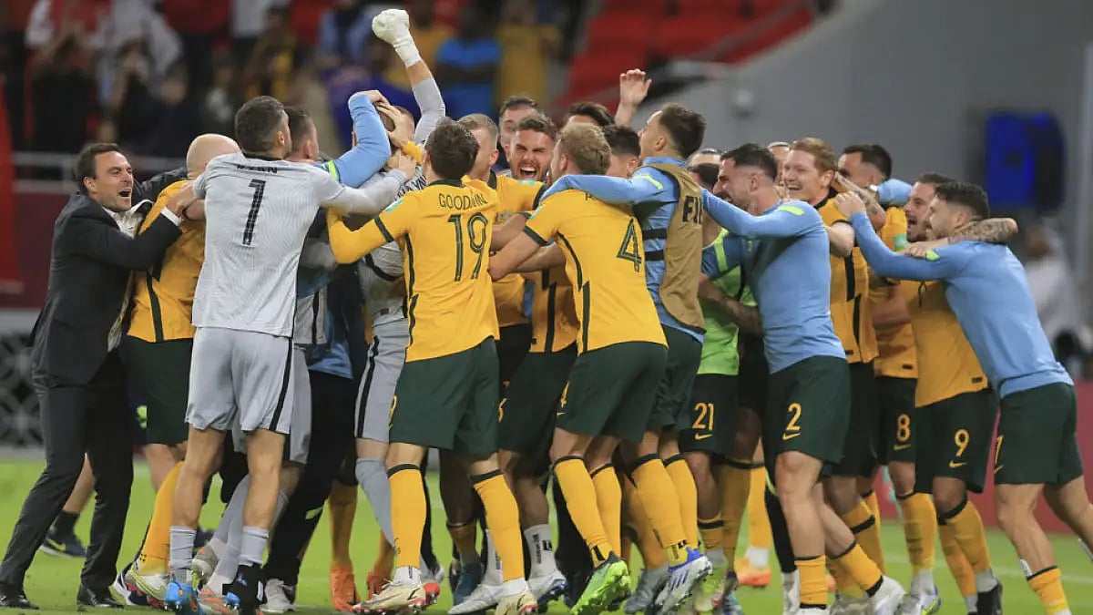 Australian players celebrate after beating Peru during their World Cup 2022 qualifying play-off in Al Rayyan, Qatar, June 13, 2022.