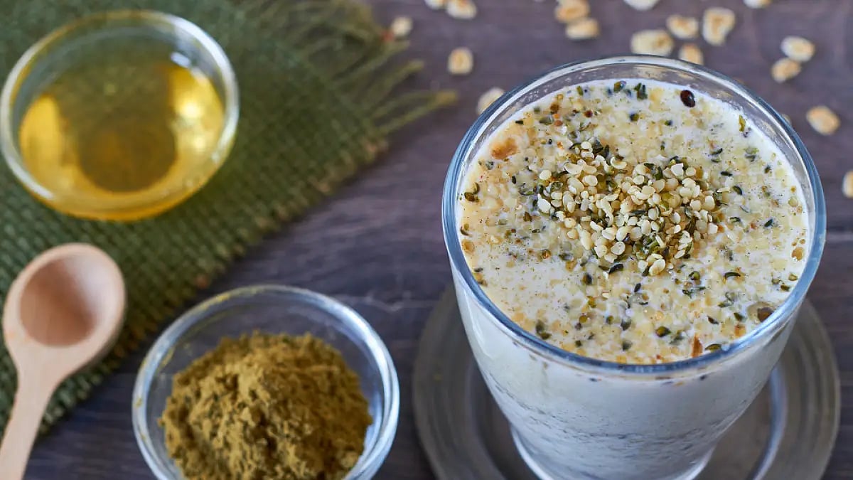 Homemade smoothie made from oats milk, shelled hemp and honey