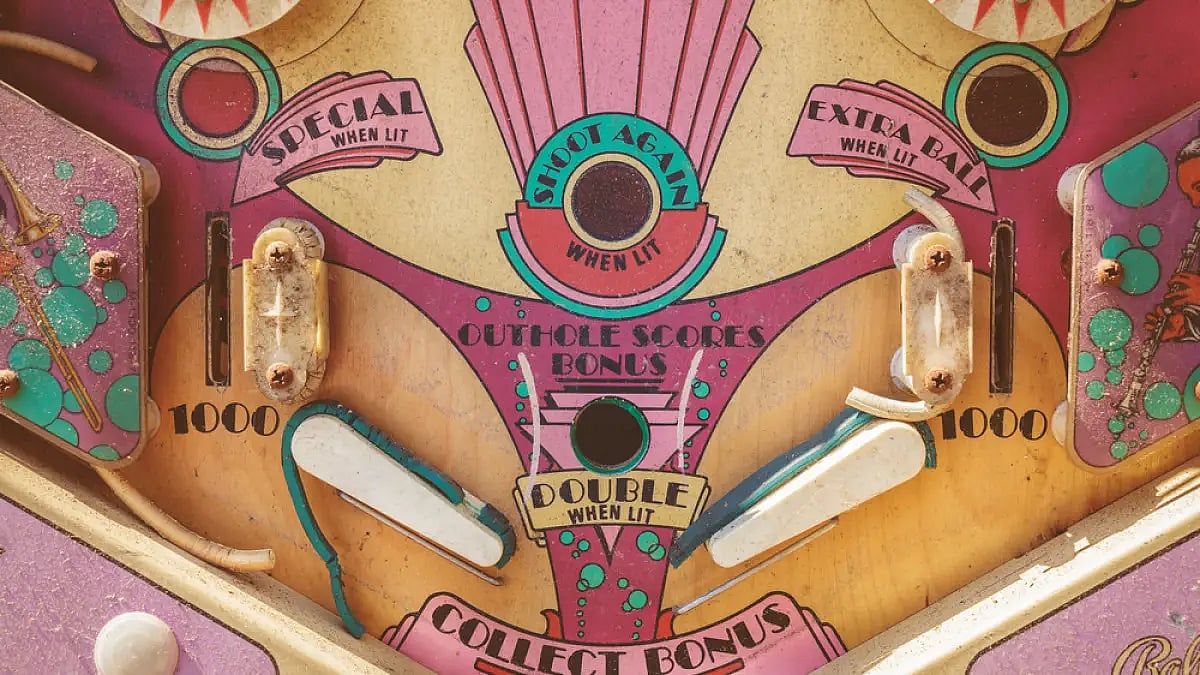 A vintage pinball machine at a flea market