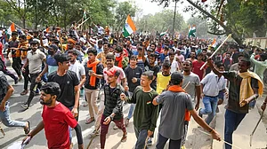 Protester block the Khagaul Road during a protest against the 'Agnipath' scheme near Patna.