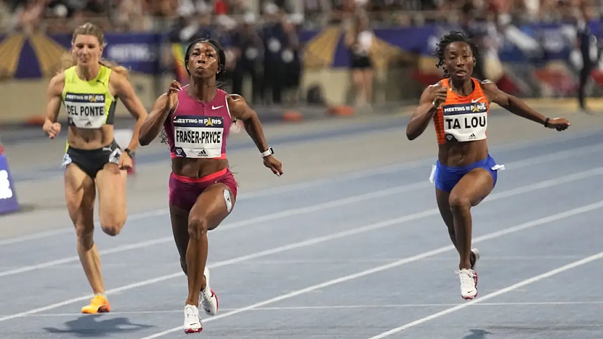 Shelly-Ann Fraser-Pryce of Jamaica, center, runs to win the 100 meters at Paris Diamond League, June 18, 2022.