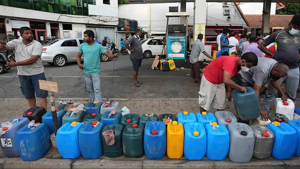 Sri Lankans line up fuel containers as the country faces fuel shortage in its worst financial crisis