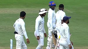Madhya Pradesh and Mumbai players walk off the field after the end of Day 1's play of the Ranji Trophy final in Bengaluru.