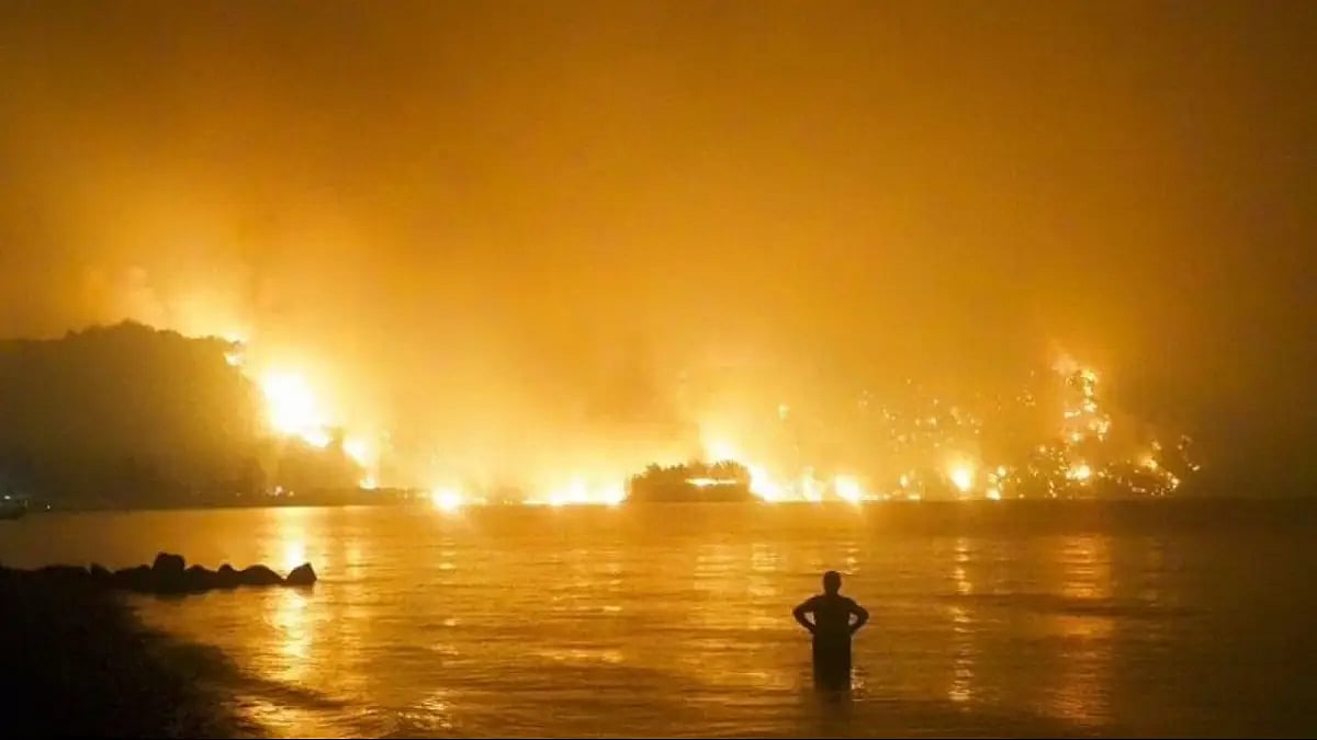 Man watches on as Flames Erupt.