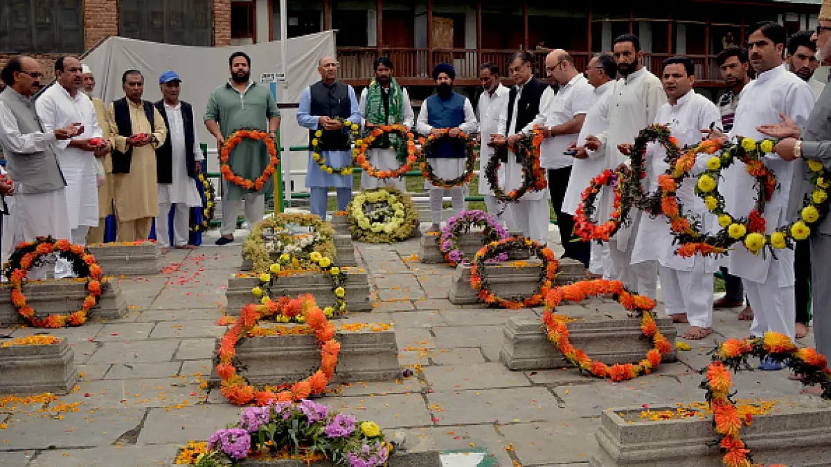 Officials lay wreaths on graves at Martyr's graveyard in Srinagar on 13 July 2018 on 'Martyrs' Day'