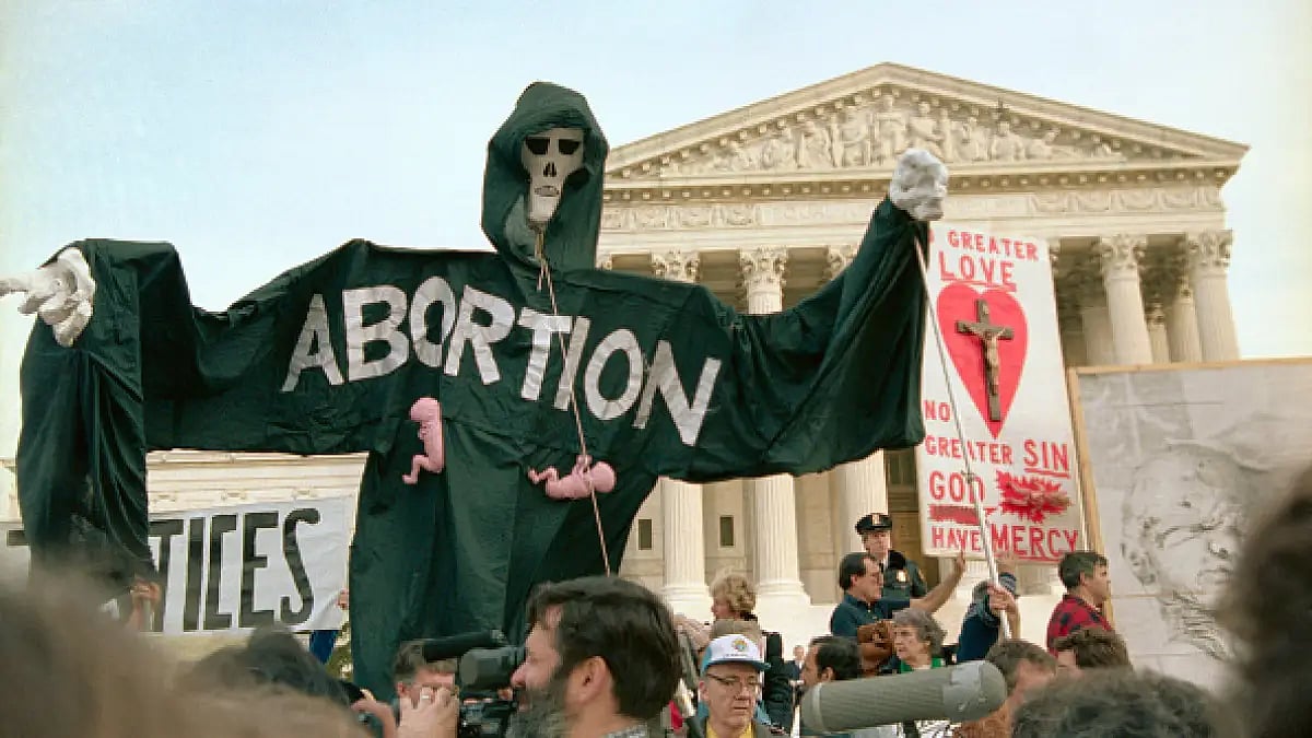 Anti-abortion demonstrators mark the 13th anniversary of Roe v. Wade, which legalized abortion.