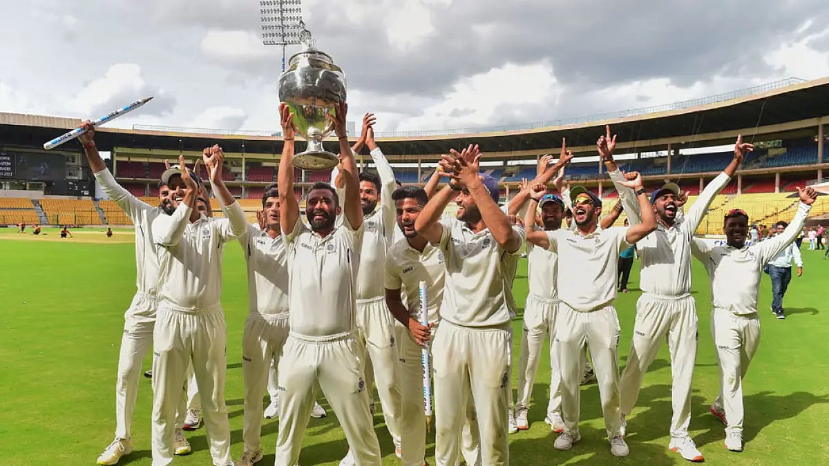 Madhya Pradesh players with the Ranji Trophy after beating in the final at Bengaluru, June 26, 2022.