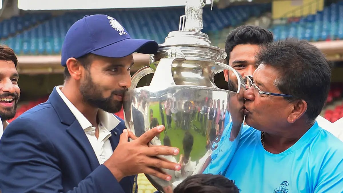 Madhya Pradesh captain Aditya Shrivastava and head coach Chandrakant Pandit kiss the trophy after winning the final Ranji Trophy match against Mumbai.