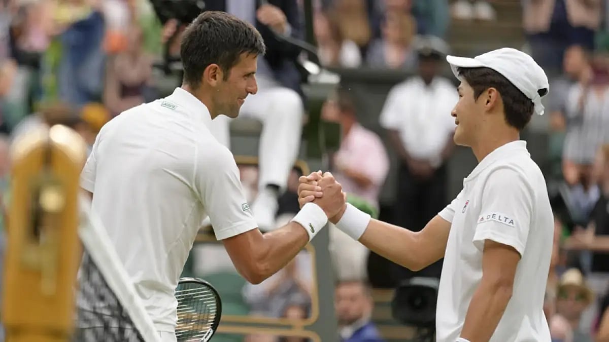 Novak Djokovic greets Kwon Soon-woo after the end of their Wimbledon 2022, first-round match.