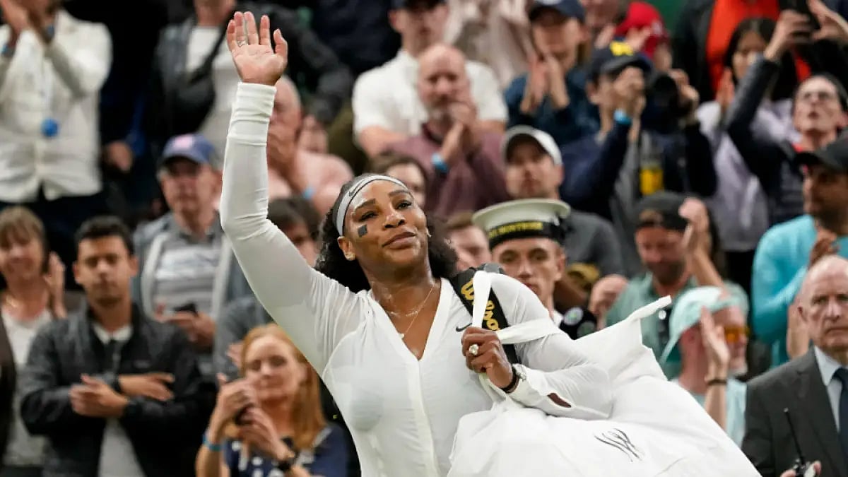 Serena Williams waves to the crowd after losing to Harmony Tan at Wimbledon 2022.