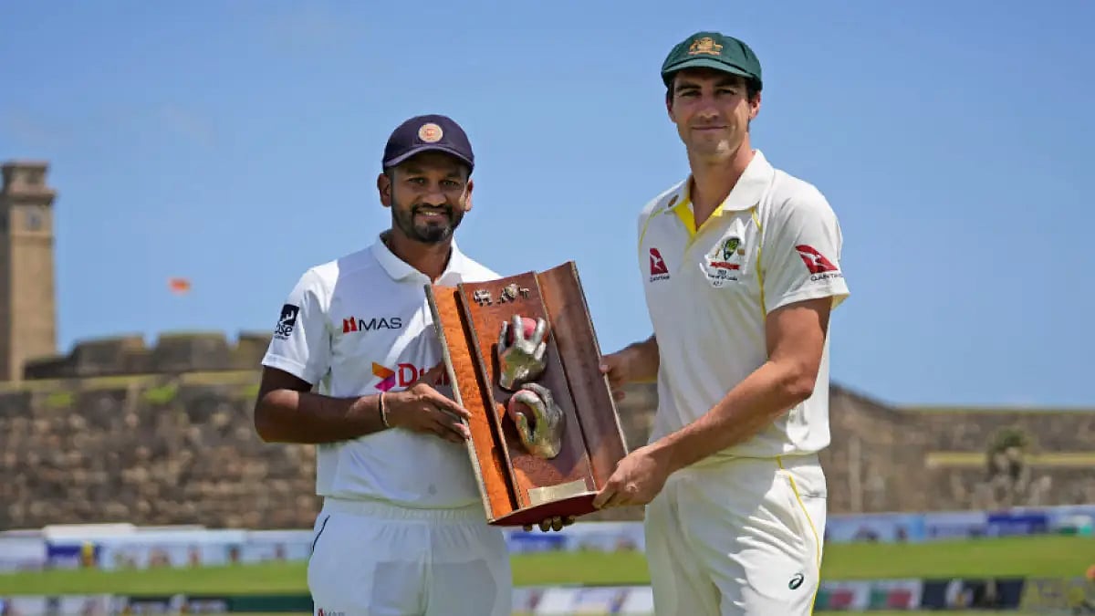 Dimuth Karunaratne and Pat Cummins pose with the Warne-Muralitharan trophy.  