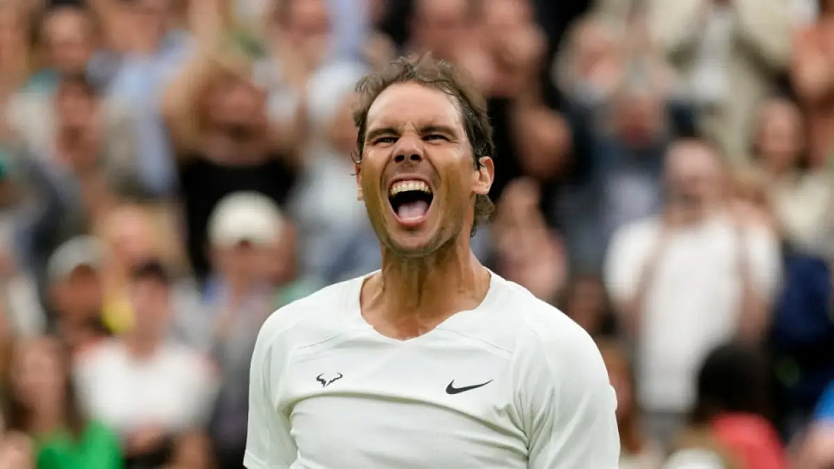 Rafael Nadal celebrates after beating Ricardas Berankis in a second round match at Wimbledon 2022.