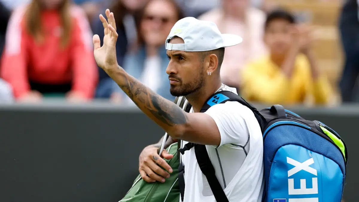 Nick Kyrgios waves to the crowds after beating Filip Krajinovic in a 2nd-round match at Wimbledon.
