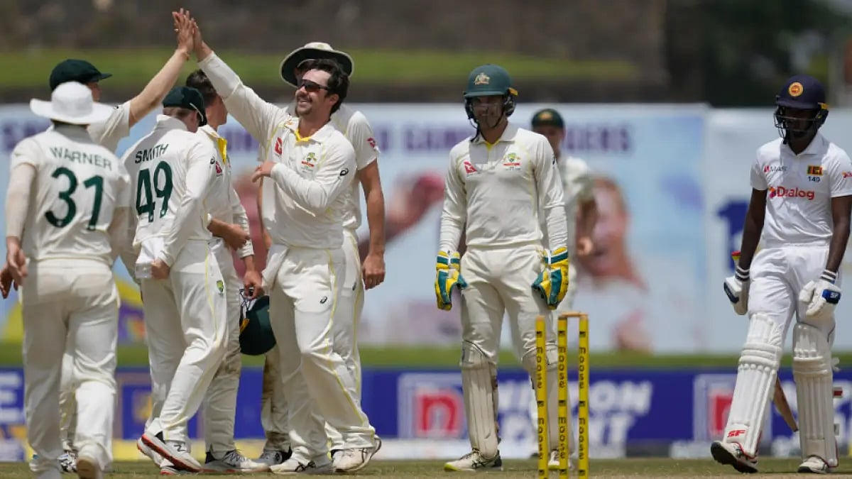 Australia players celebrate the fall of a Sri Lankan wicket on Day 3 of the first Test.  
