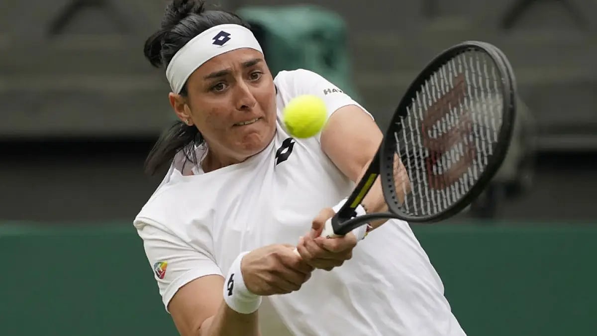 Ons Jabeur returns the ball to Diane Parry during their Wimbledon 2022 third round match.