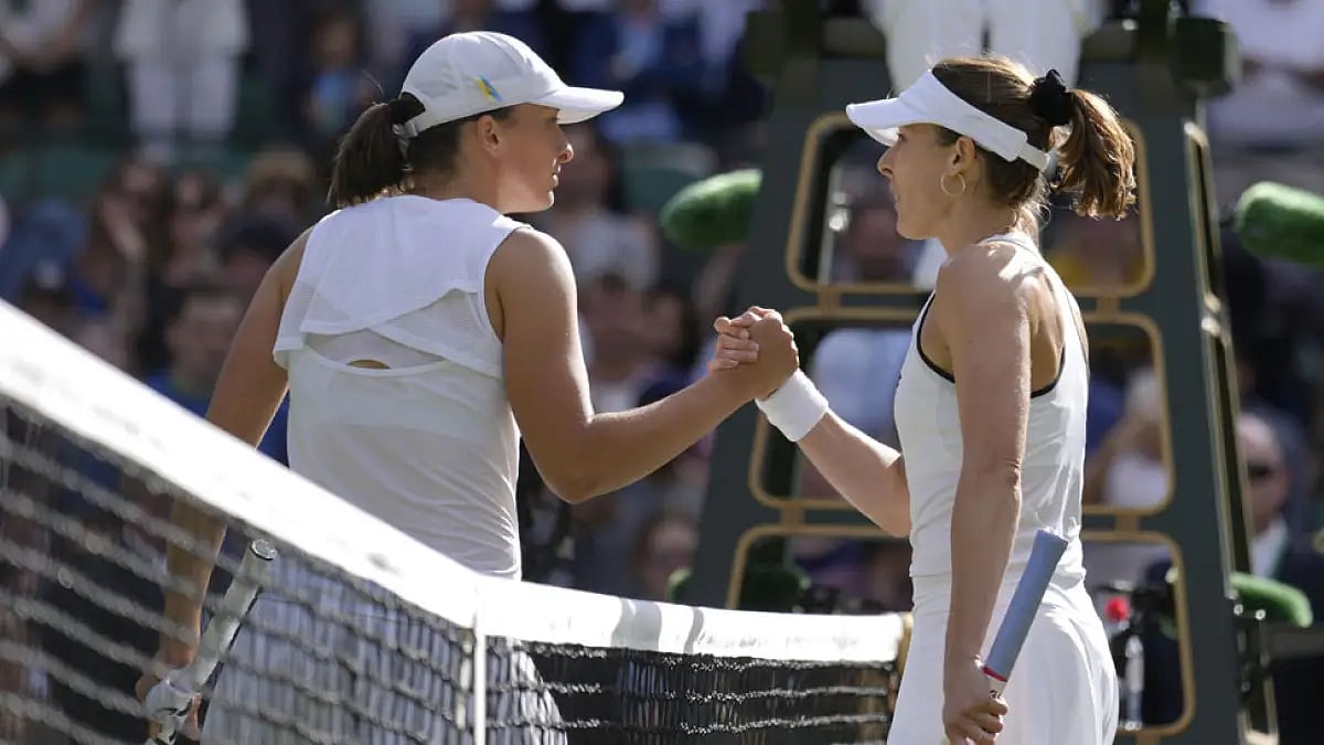 Alize Cornet, right, greets Iga Swiatek after their Wimbledon 2022, women's singles third round match.