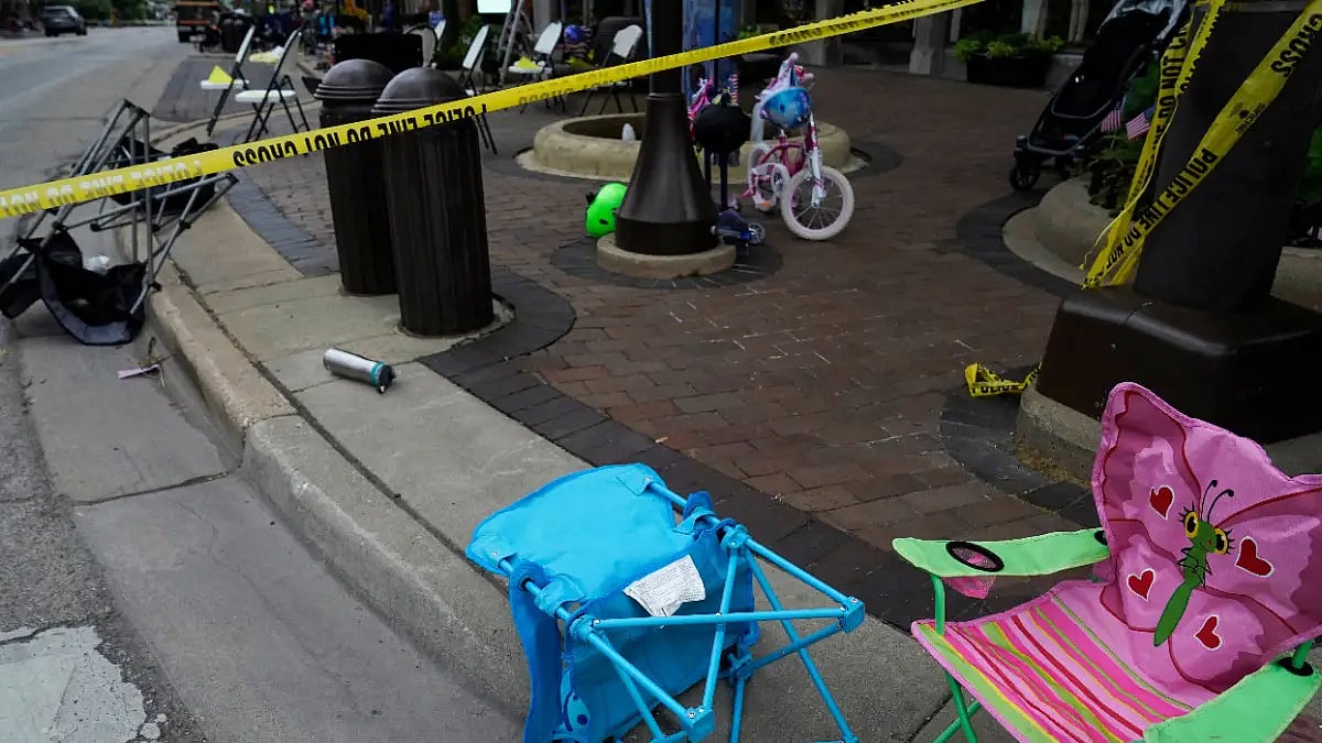 Empty chairs, bicycle are seen after a mass shooting at the Highland Park Fourth of July parade