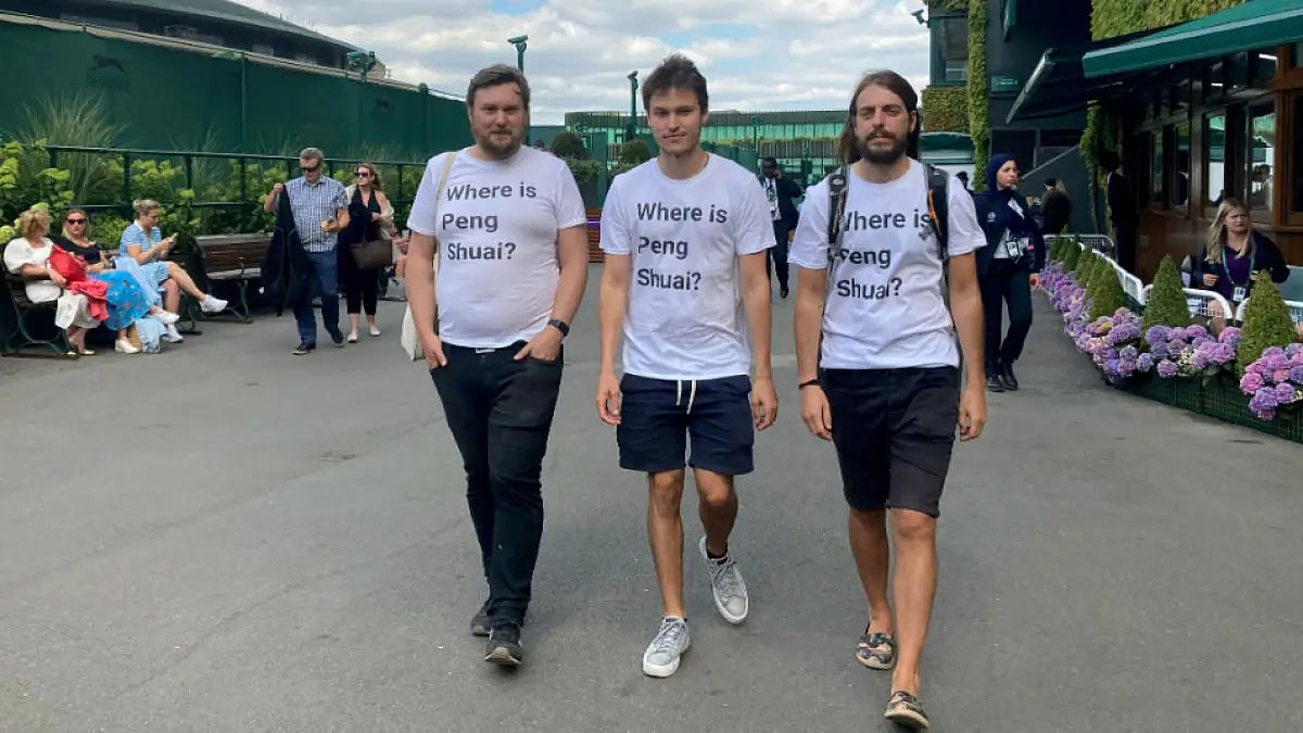 Protesters pose for the media in T-shirts reading 'Where is Peng Shuai' at Wimbledon 2022.