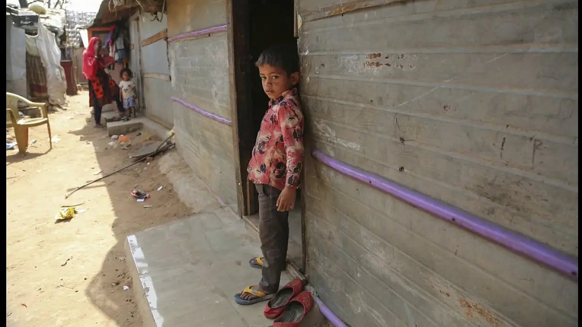 A Rohingya refugee child stands at a makeshift camp on the outskirts of Jammu, India.