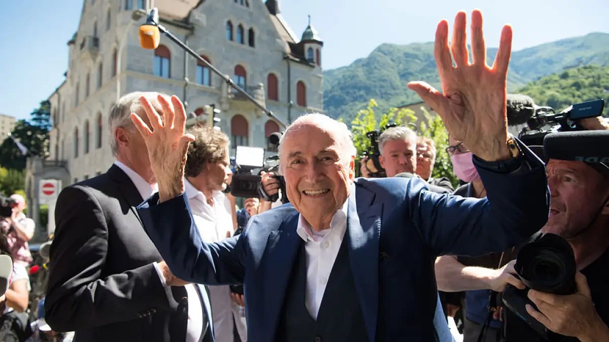 Joseph Blatter, center, waves in front of the Swiss Federal Criminal Court in Bellinzona, Switzerland, July 8, 2022.