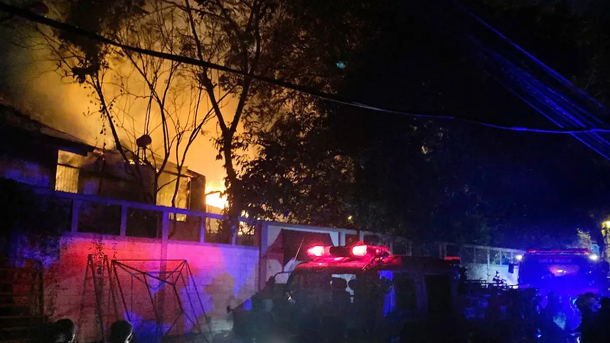 Firefighters try to douse a fire at Sri Lankan Prime Minister Ranil Wickremesinghe's house