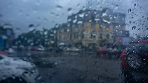 Raindrops falling on wet glass