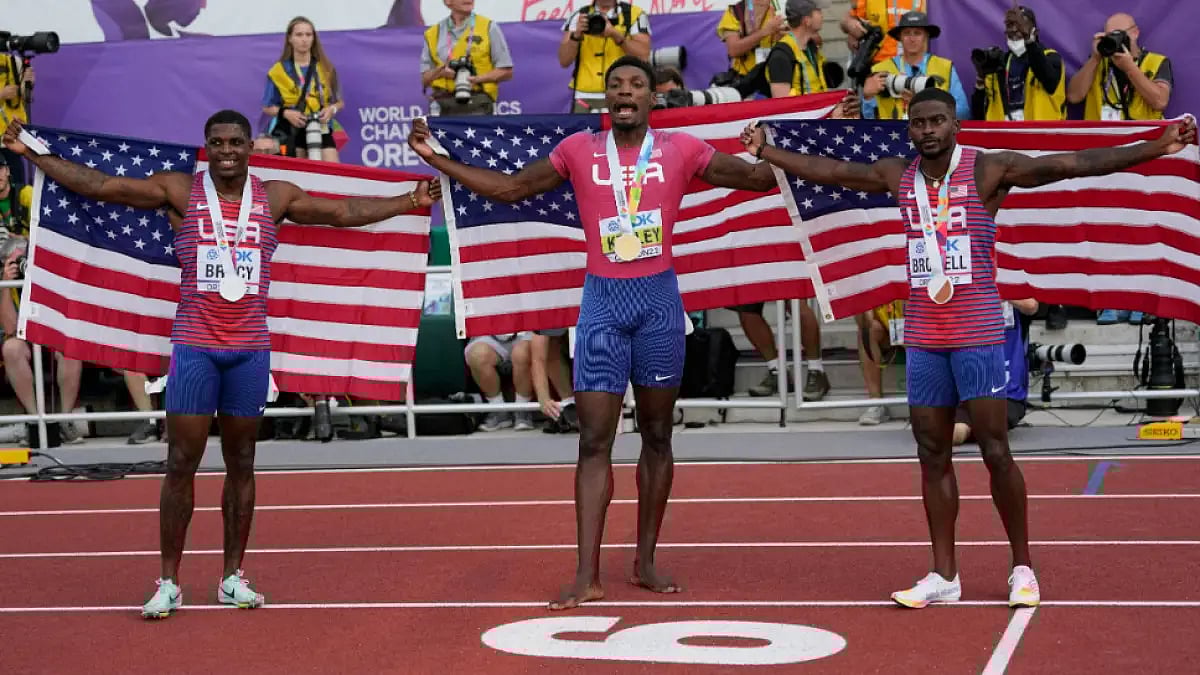 Fred Kerley (C), Marvin Bracy (R) and Trayvon Bromell pose after clean sweeping men's 100m.