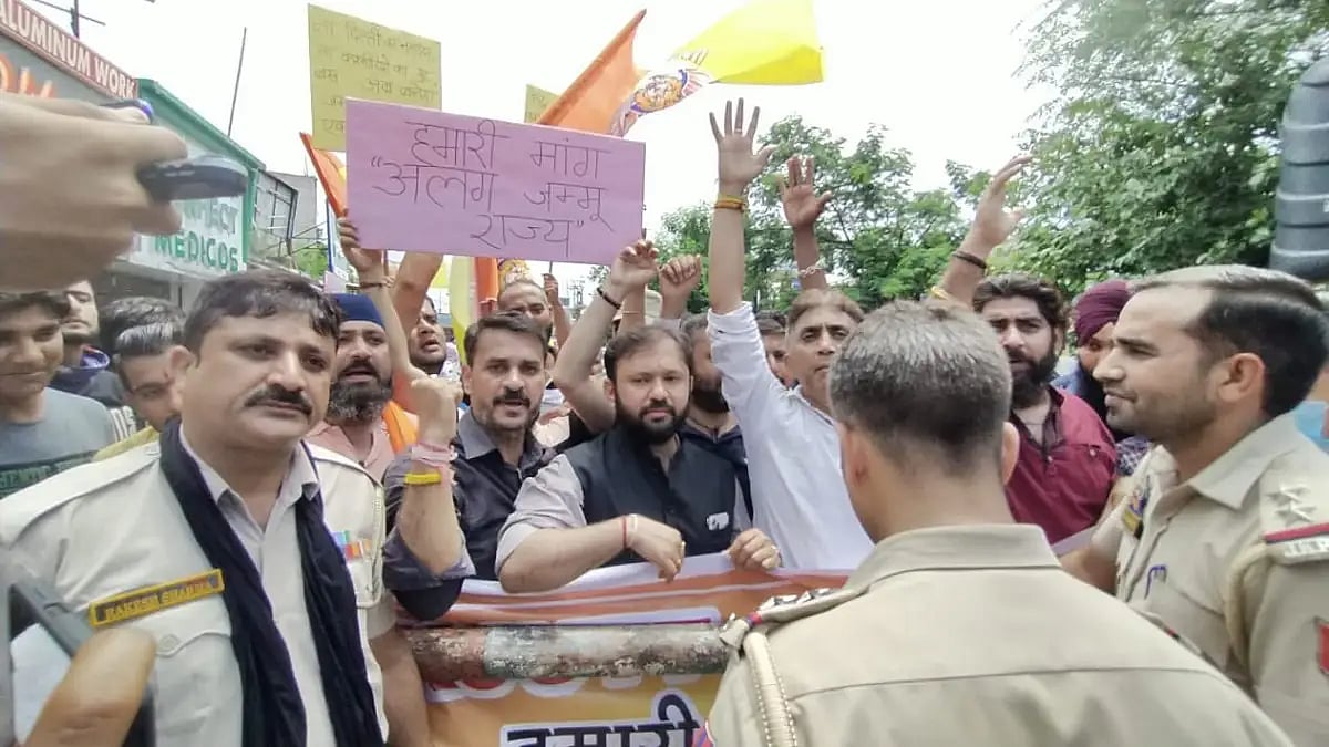 Protester with a poster reading 'Our demand: Separate Jammu state'