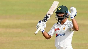 Abdullah Shafique celebrates after completing his century against Sri Lanka in Galle.