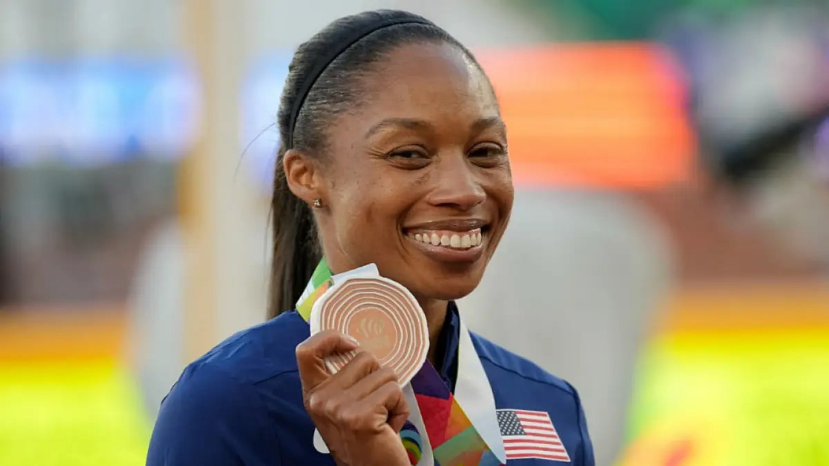 Allyson Felix holds a bronze medal at the World Athletics Championships 2022.