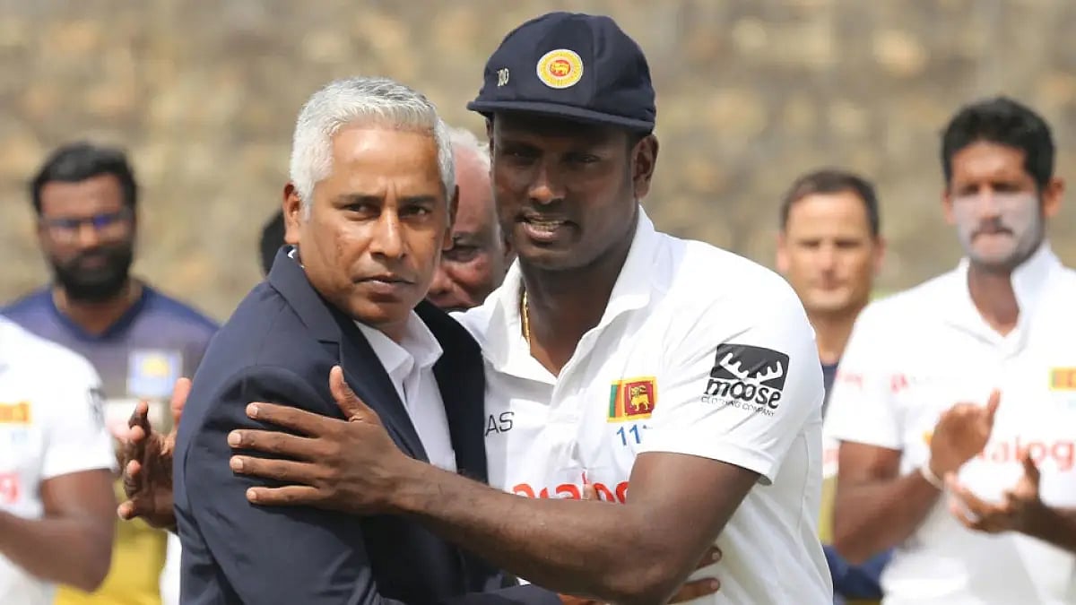 Chaminda Vaas presents Angelo Mathews with a special cap to mark the all-rounder's 100th Test match.