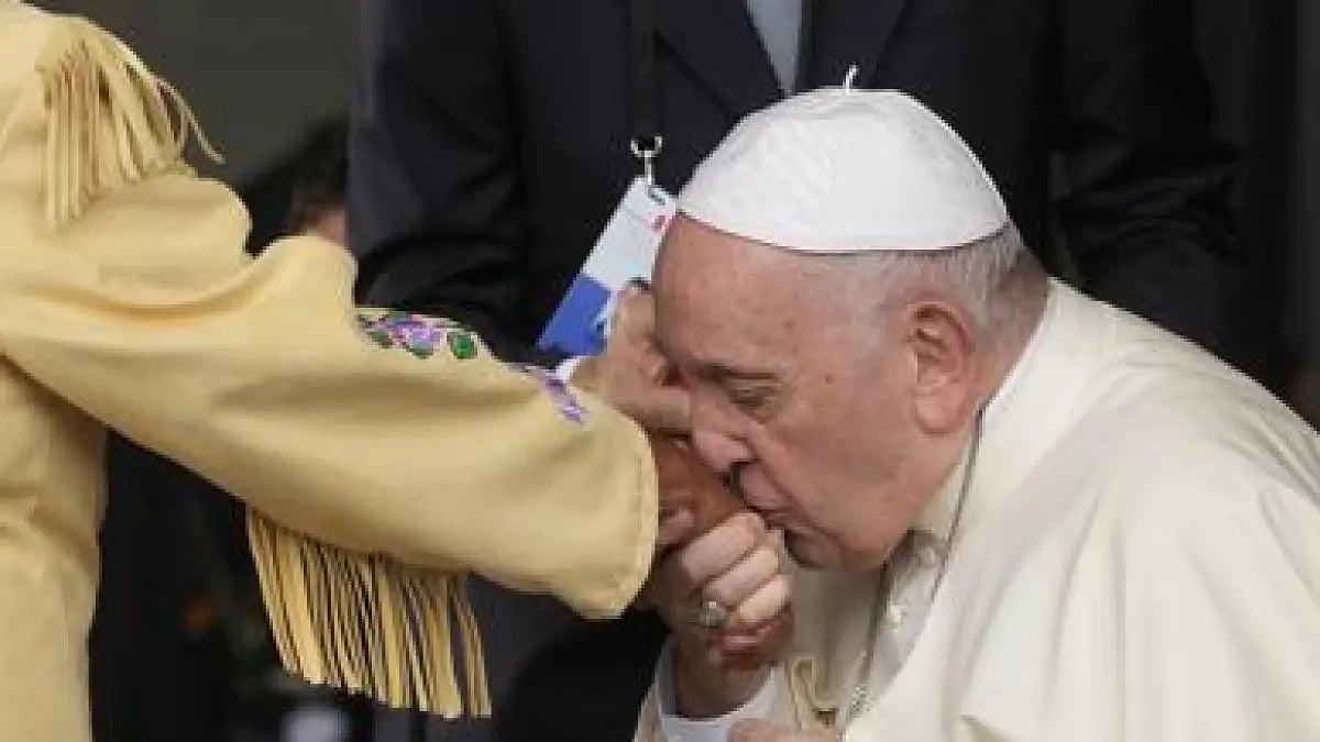 Pope Francis kissed the hand of a survivor as he was greeted at the Edmonton, Alberta, airport.