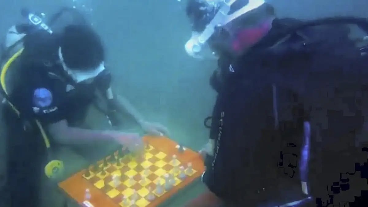 Scuba divers play a game of chess underwater during the ongoing 44th International Chess Olympiad
