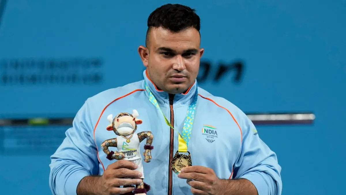 India's Sudhir poses with the Commonwealth Games 2022 Para Powerlifting gold medal. 