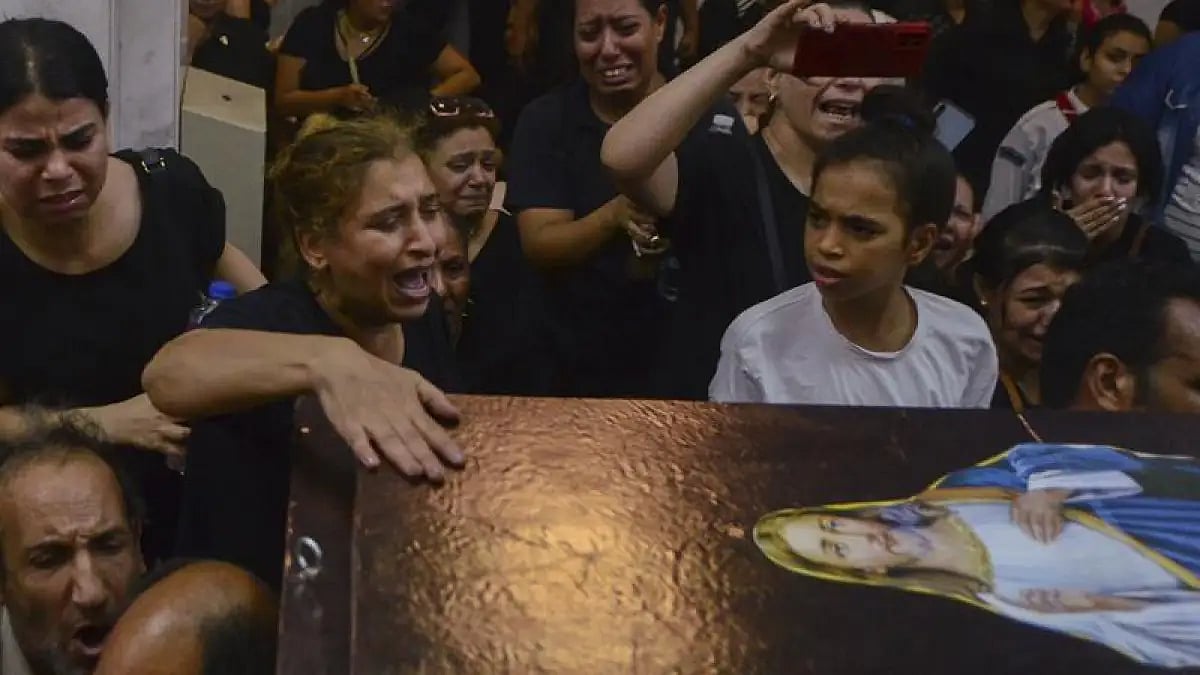 Mourners attend a memorial service for victims of a fire at a church in Greater Cairo 