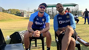 Shikhar Dhawan (R) shares a smile with Axar Patel during India's training session in Harare.