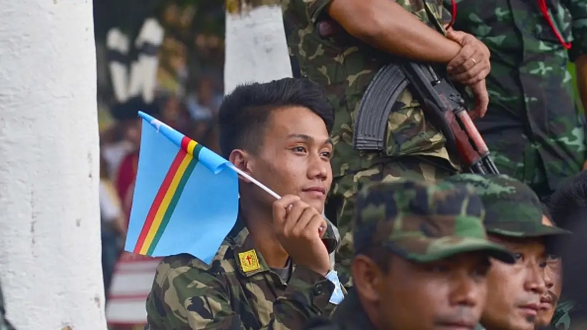 A cadre of National Socialist Council of Nagaland-Isak Muivah (NSCN-IM) holds a Naga flag