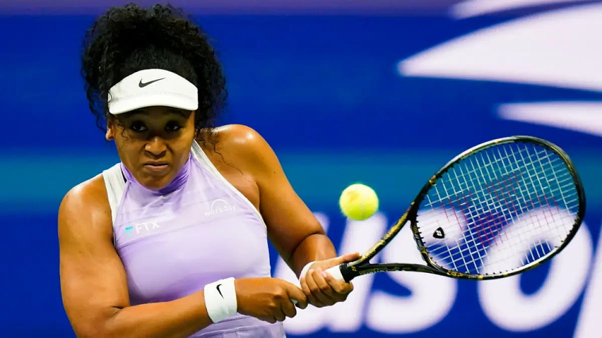 Naomi Osaka returns a shot to Danielle Collins in first round of the US Open.
