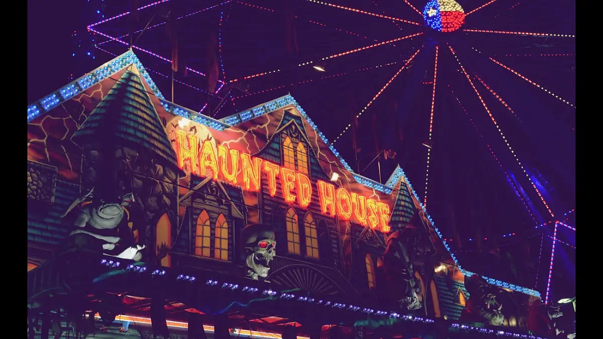 The haunted house and ferris wheel at the historic Fair Park in Texas. The fair has taken place ever