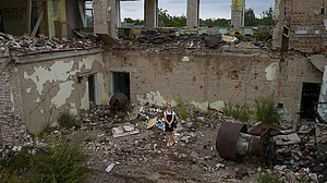 Anastasia Avramenko, 13, stands in the rubble of her former classroom in Ukraine.