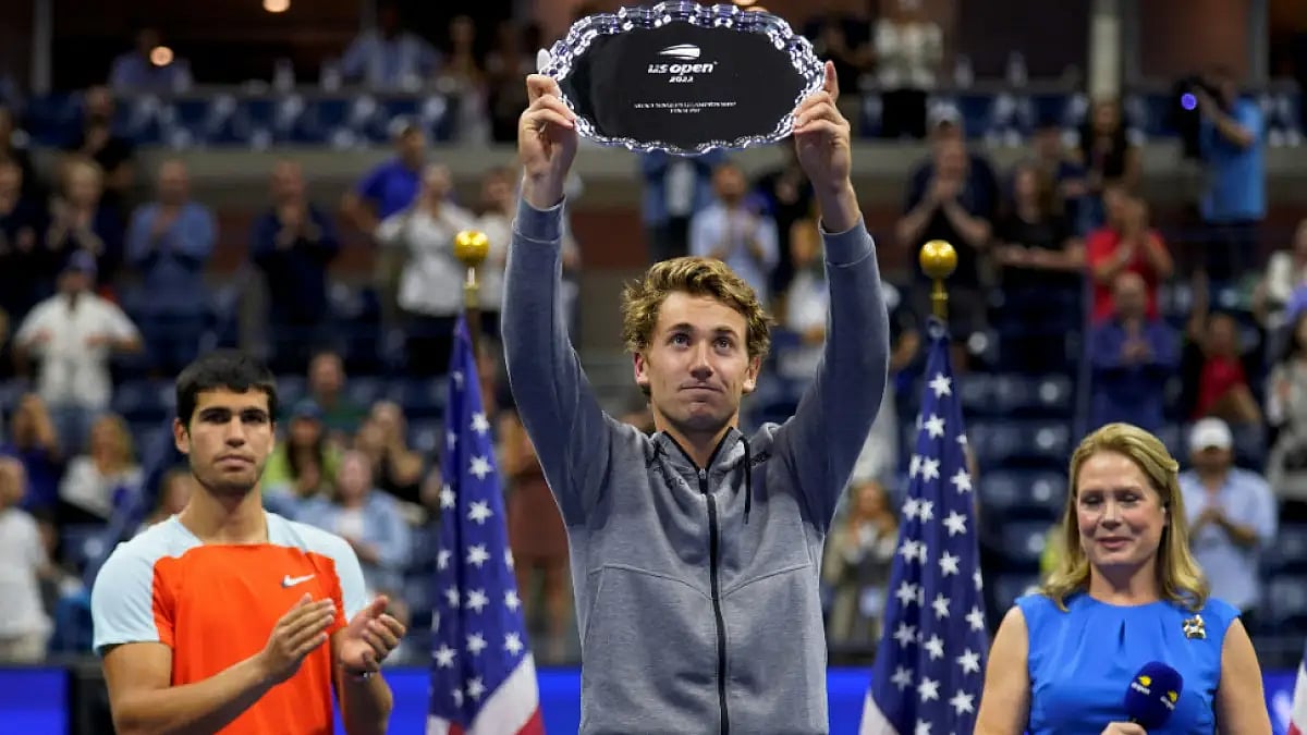 Casper Ruud holds up the runner-up trophy after losing to Carlos Alcaraz at US Open.