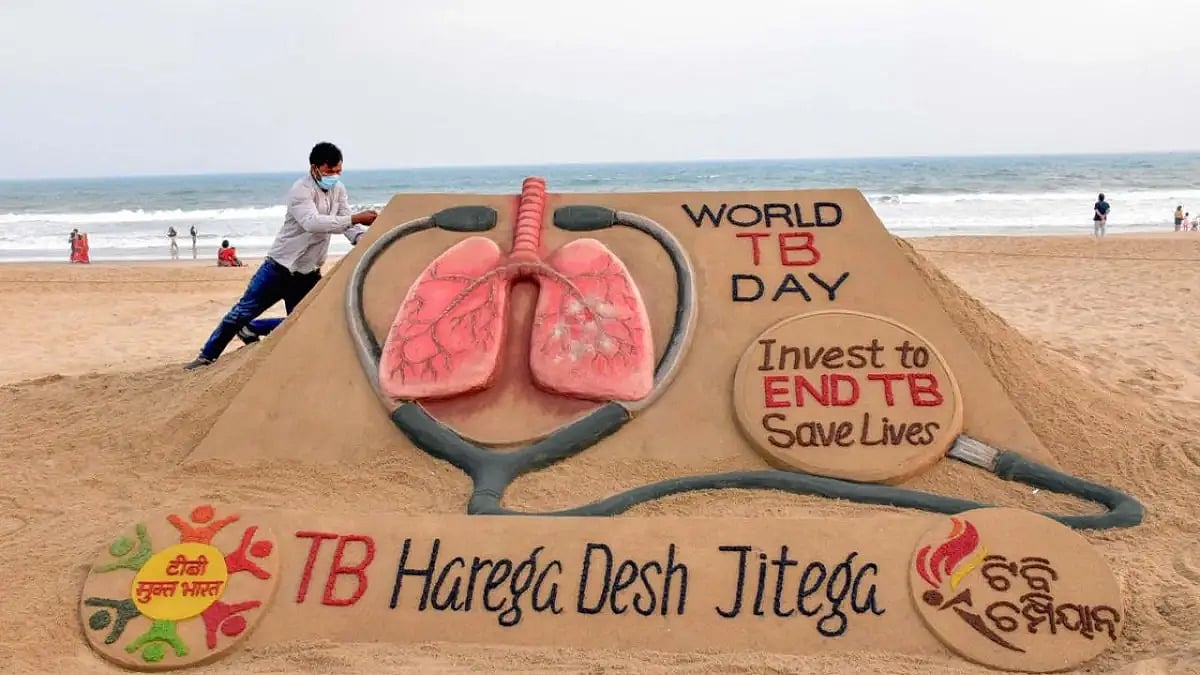 Sand artist Sudarshan Pattanaik makes a sand sculpture on the eve of World Tuberculosis Day, at Puri