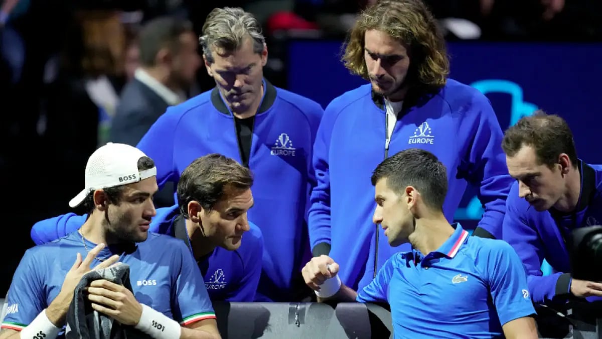 Novak Djokovic (R) and Matteo Berrettini (L) talk to Roger Federer during a Laver Cup match.