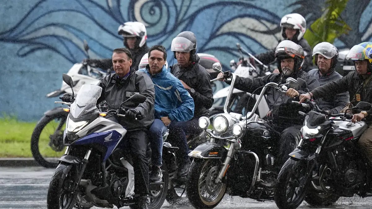 Jair Bolsonaro arrived at the Neymar Jr. Institute, outside Sao Paulo, after riding a motorcycle alongside supporters.