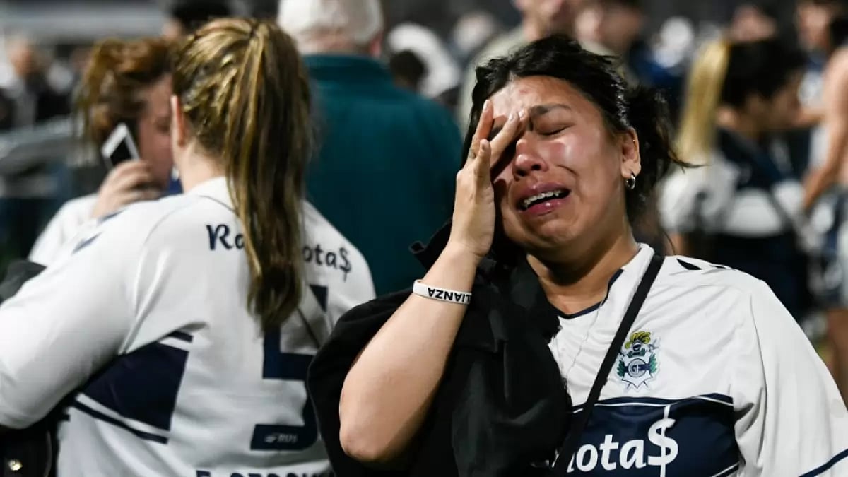 Gimnasia fans react to tear gas on the field during a match against Boca Juniors in La Plata.