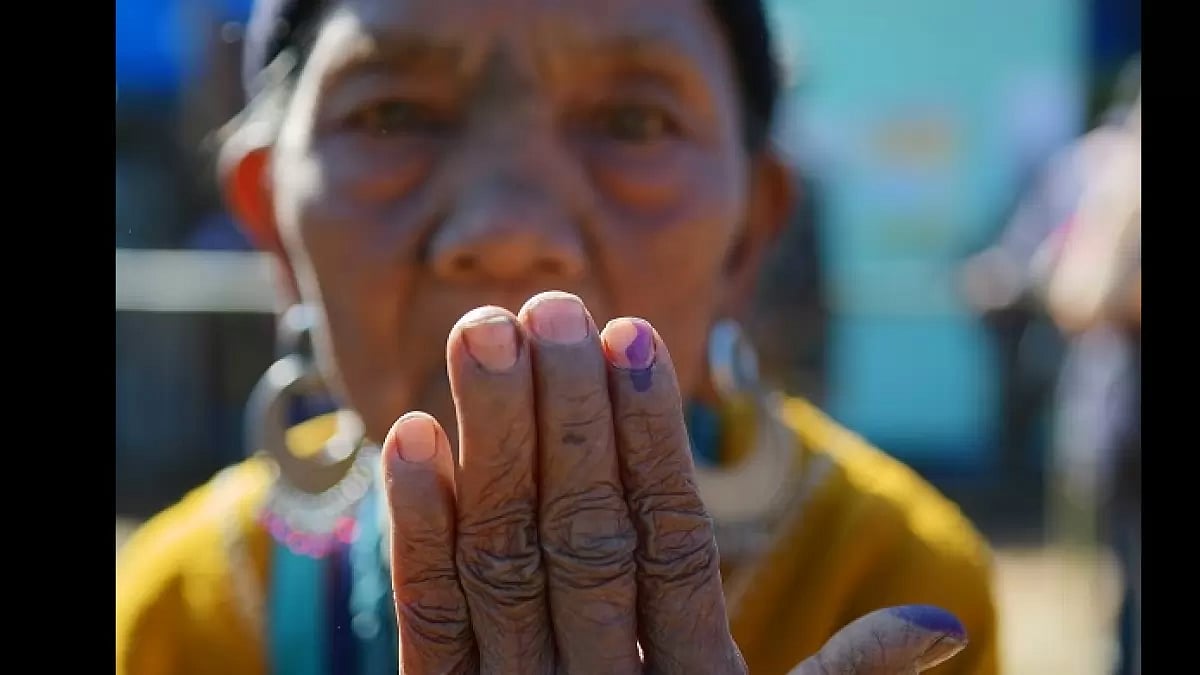 A Bru refugee seen showing off her ink mark after casting her vote at the Kanhmun