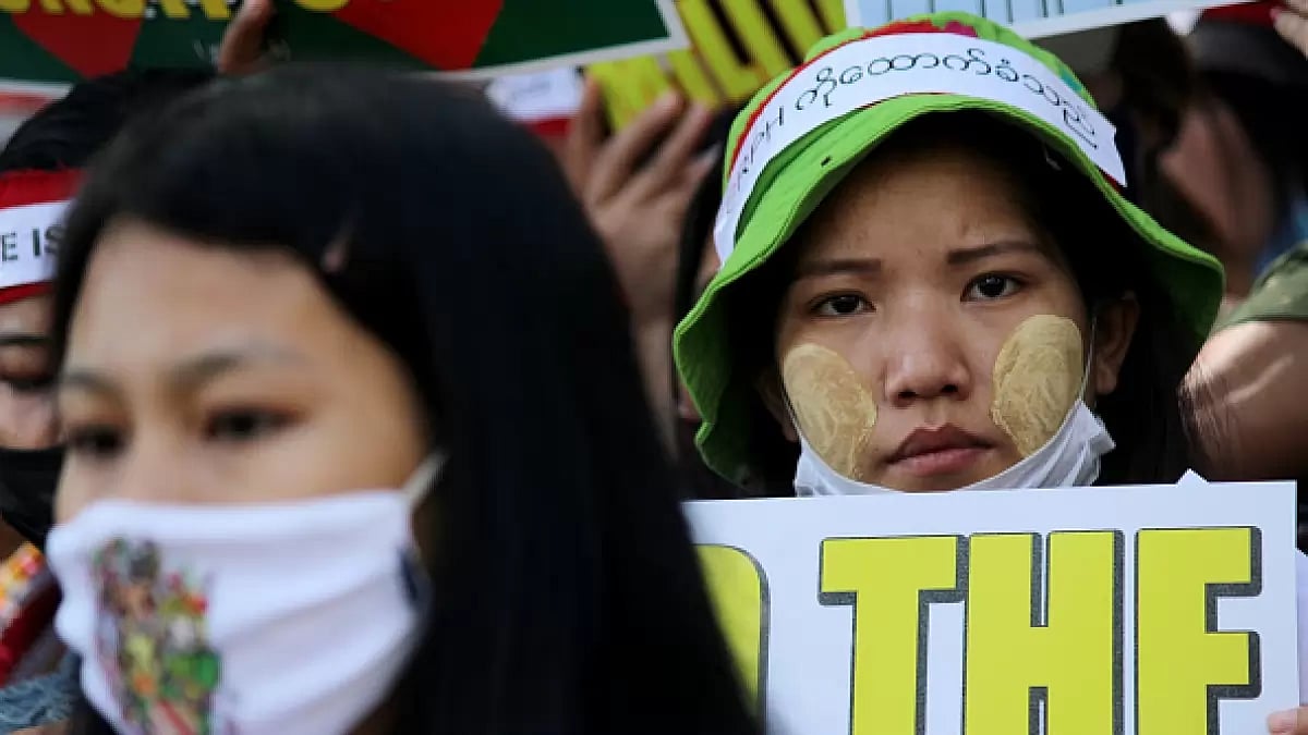A Chin refugee from Myanmar holds a placard during a protest against the military coup in Myanmar, i
