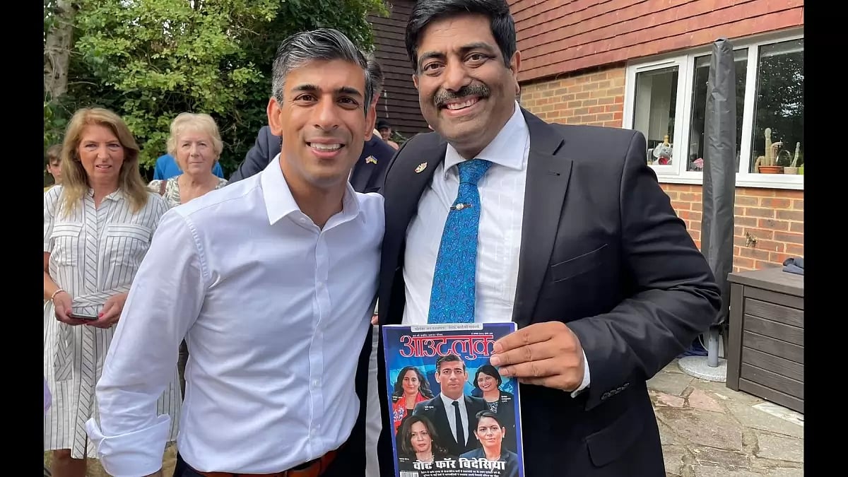  Rishi Sunak with UK Councillor Sharad Jha, holding a copy of Outlook Hindi in London.